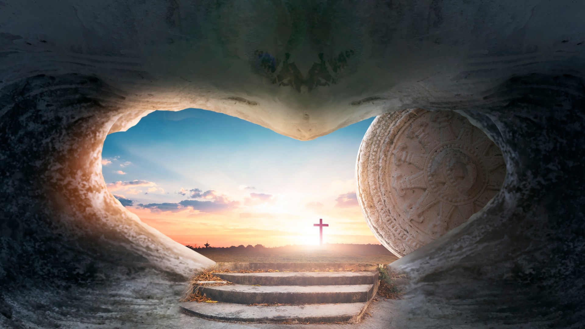 Tomb opened with cross showing through with beautiful sky